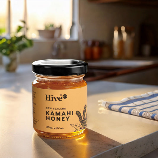 Jar of New ZealandHive 175 Kamahi Honey on a kitchen counter